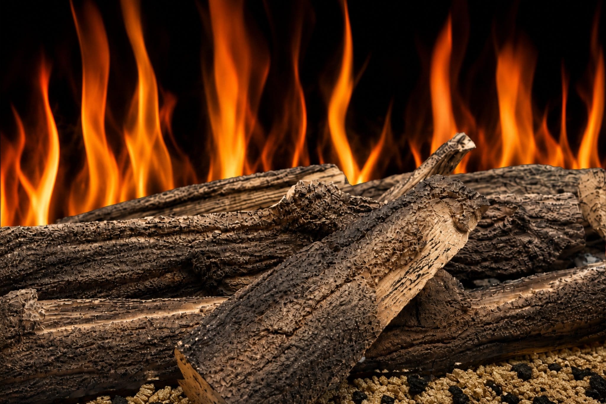 Woodland log set close-up showing realistic textured logs, glowing fuel bed and orange flame effect from Evolution Fires.