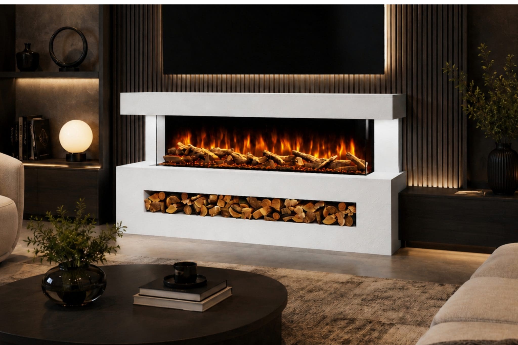 This straight-on room view shows the Davinci electric fireplace suite in a White Textured finish, styled in a luxury living room with a wall-mounted TV above. The image highlights the clean white textured surround, wide flame display, realistic log bed and decorative log storage area beneath, giving customers a clear front-facing view of the Davinci suite. Use this image on the Davinci product page, WooCommerce gallery or Meta catalogue to show the White Textured finish from a straight-on angle and help customers understand the full fireplace layout.